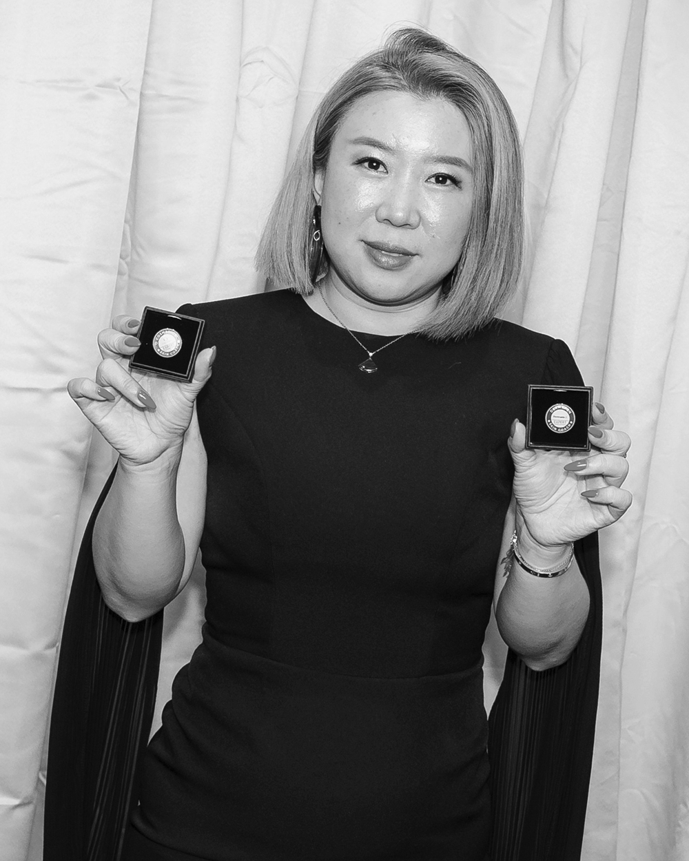 Lady holding awards smiling