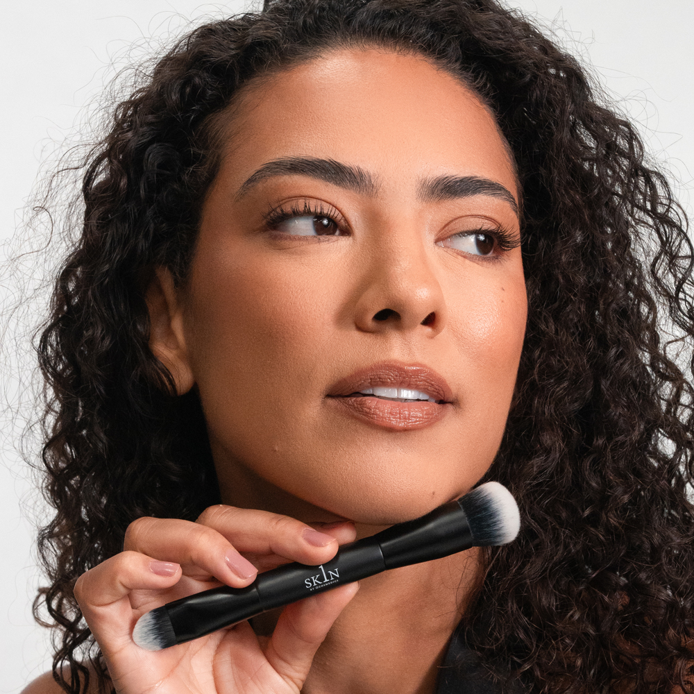 Lady holding 1SKIN The Ultimate Makeup Brush