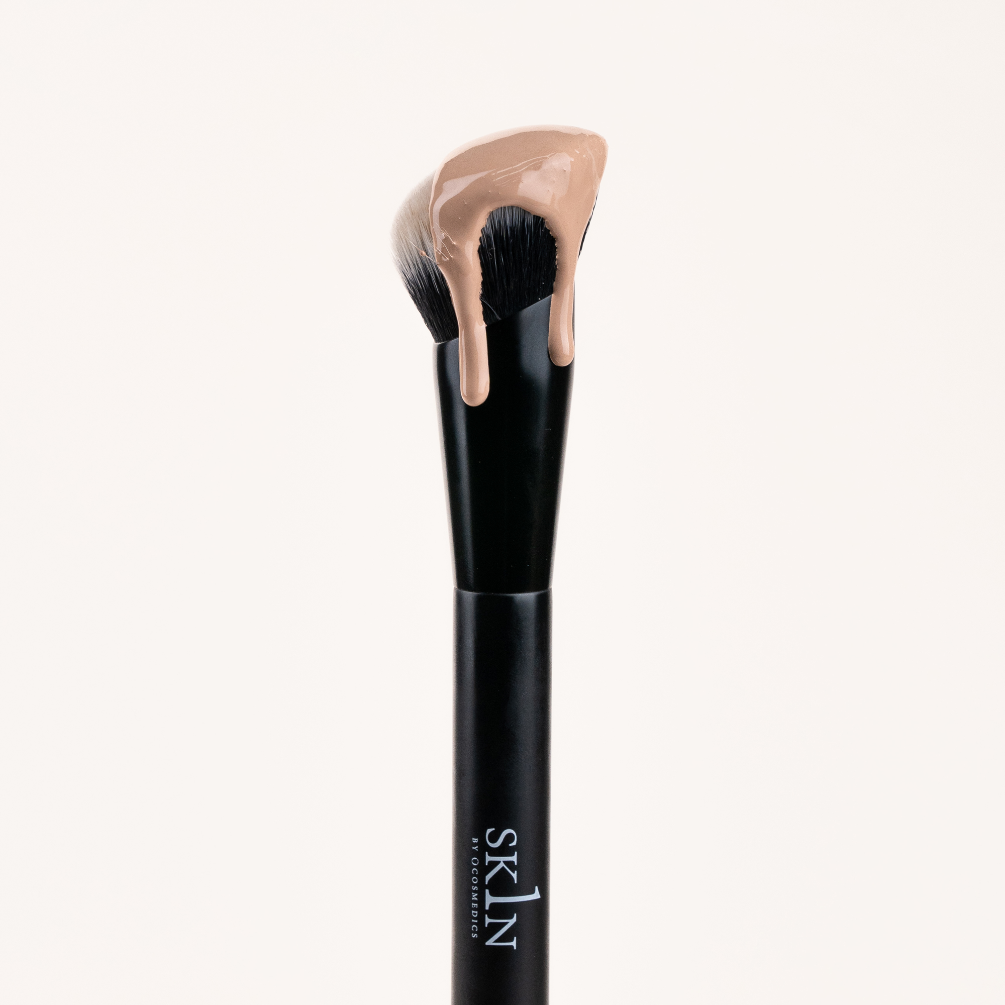 1Skin Seamless Complexion brush with foundation on it