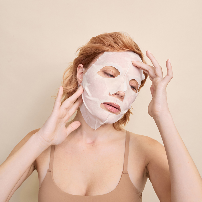 Lady with Dp Dermaceuticals Brite Lite 3D Sculptured Mask on face