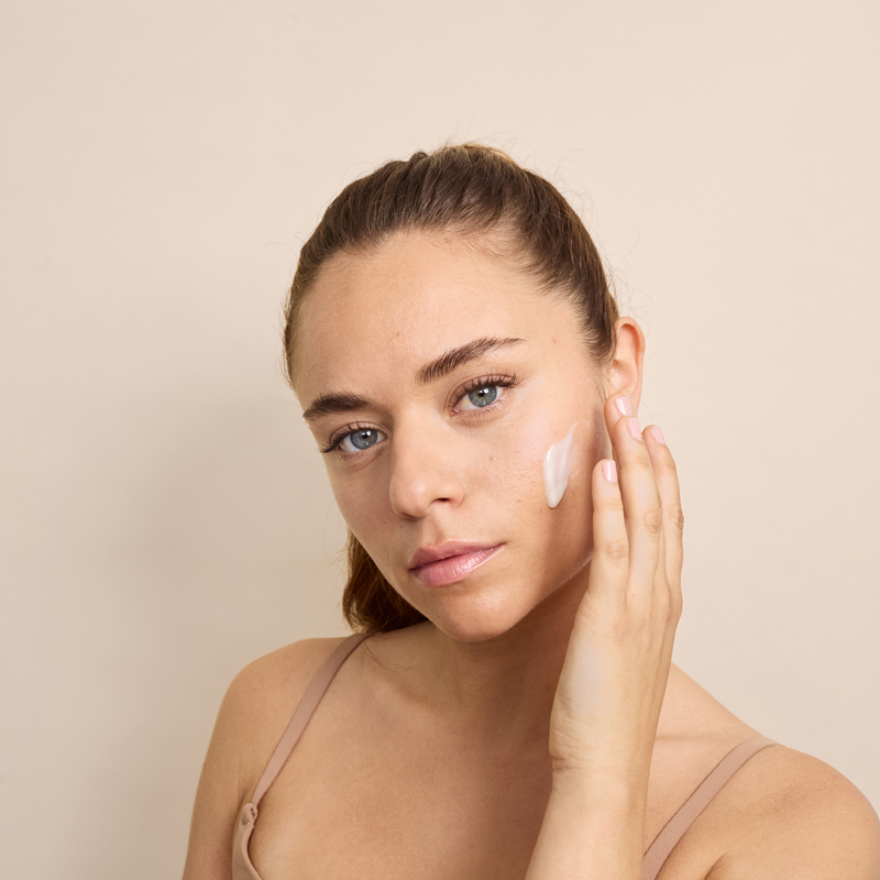 Lady applying Dp Dermaceuticals Brite Lite on face