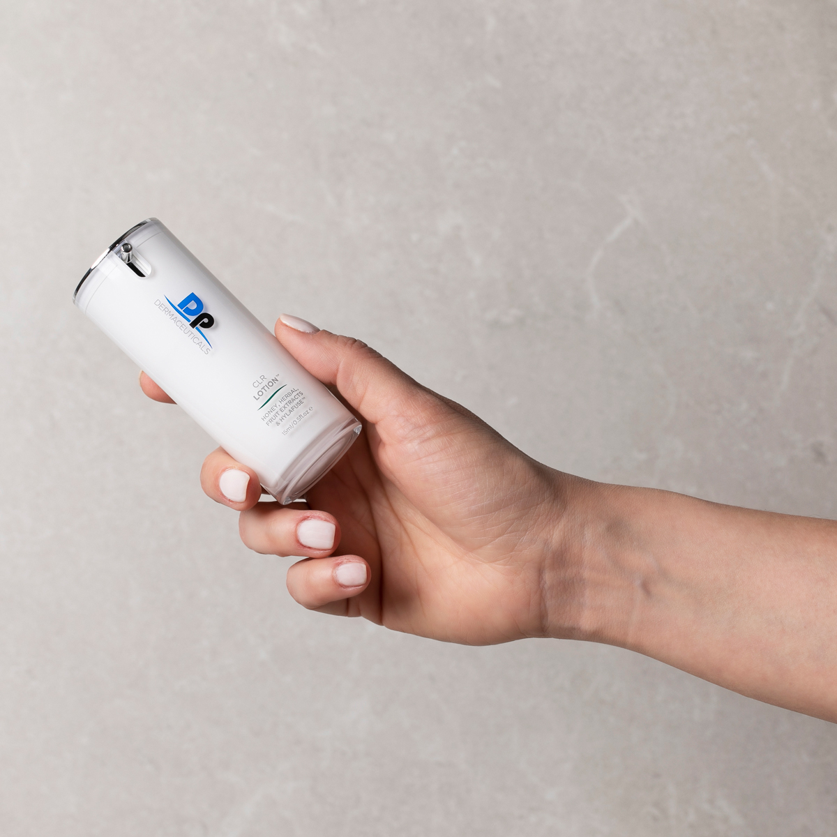 Person holding Dp Dermaceuticals CLR Lotion in hand
