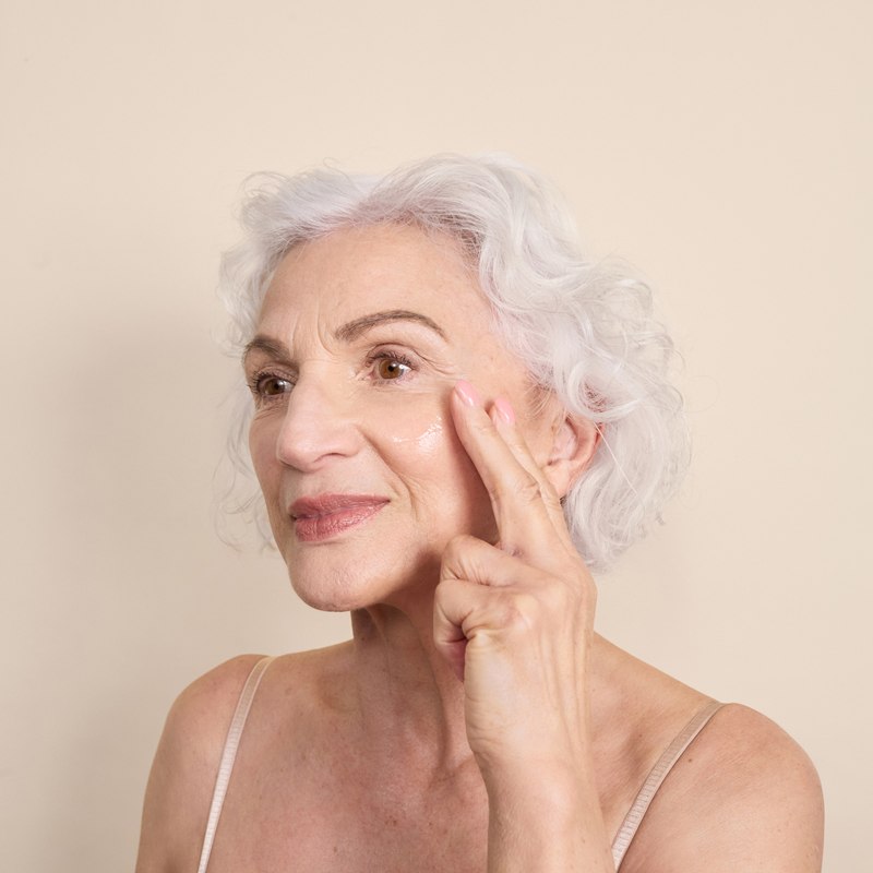 Lady applying Dp Dermaceuticals Exo-Skin Serum to face