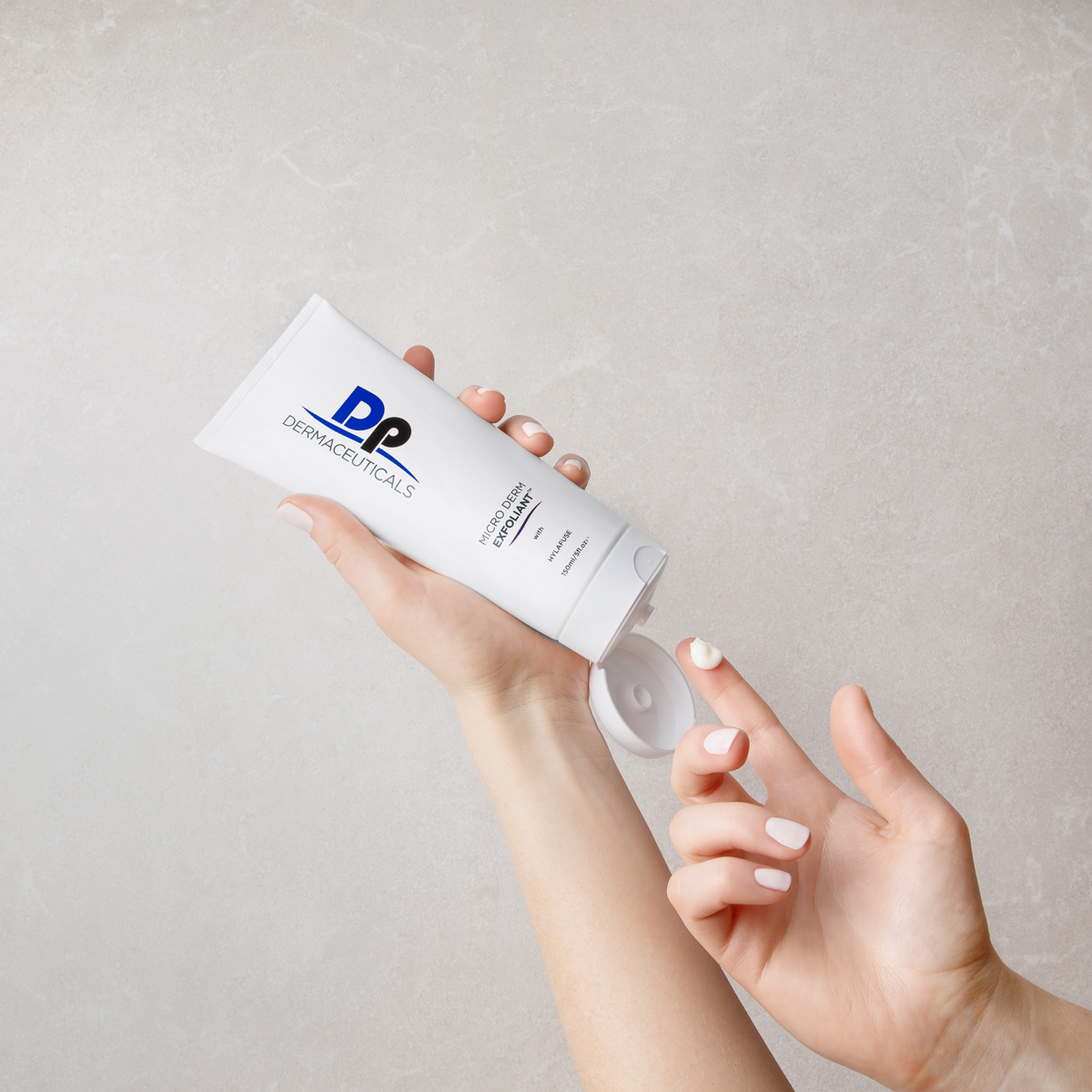 Person putting Dp Dermaceuticals Micro-Derm Exfoliant on finger