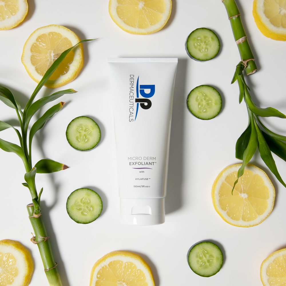 Dp Dermaceuticals Micro-Derm Exfoliant product with lemons and limes around it