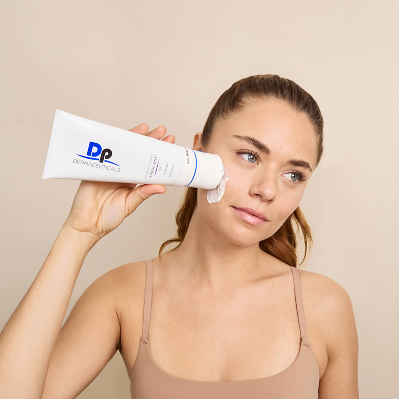 Lady applying Dp Dermaceuticals Micro Derm Exfoliant on face