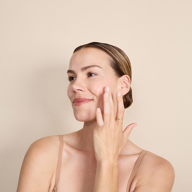Woman applying Dp Dermaceuticals Antioxidant Cocktail to face