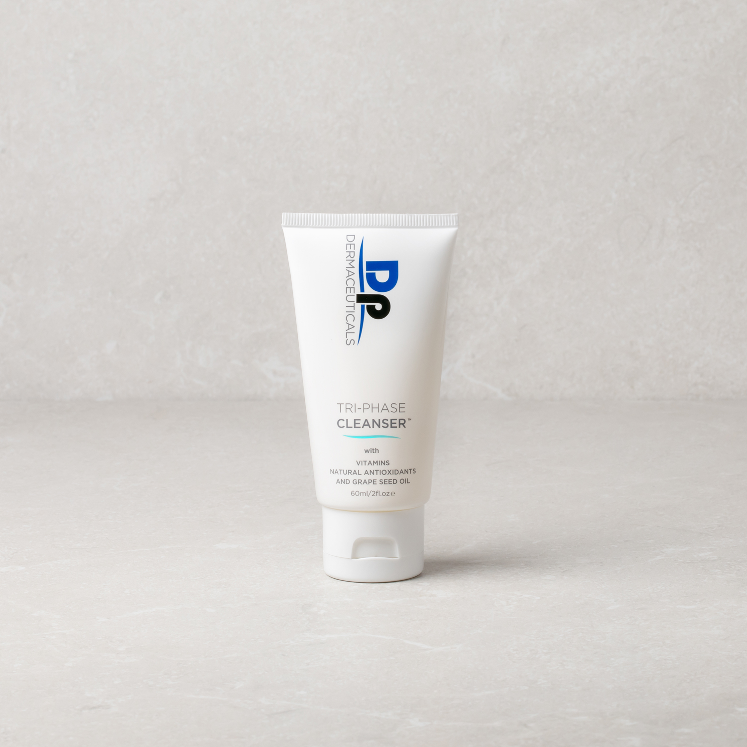 Dp Dermaceuticals Tri-Phase Cleanser 60ml in front of grey background