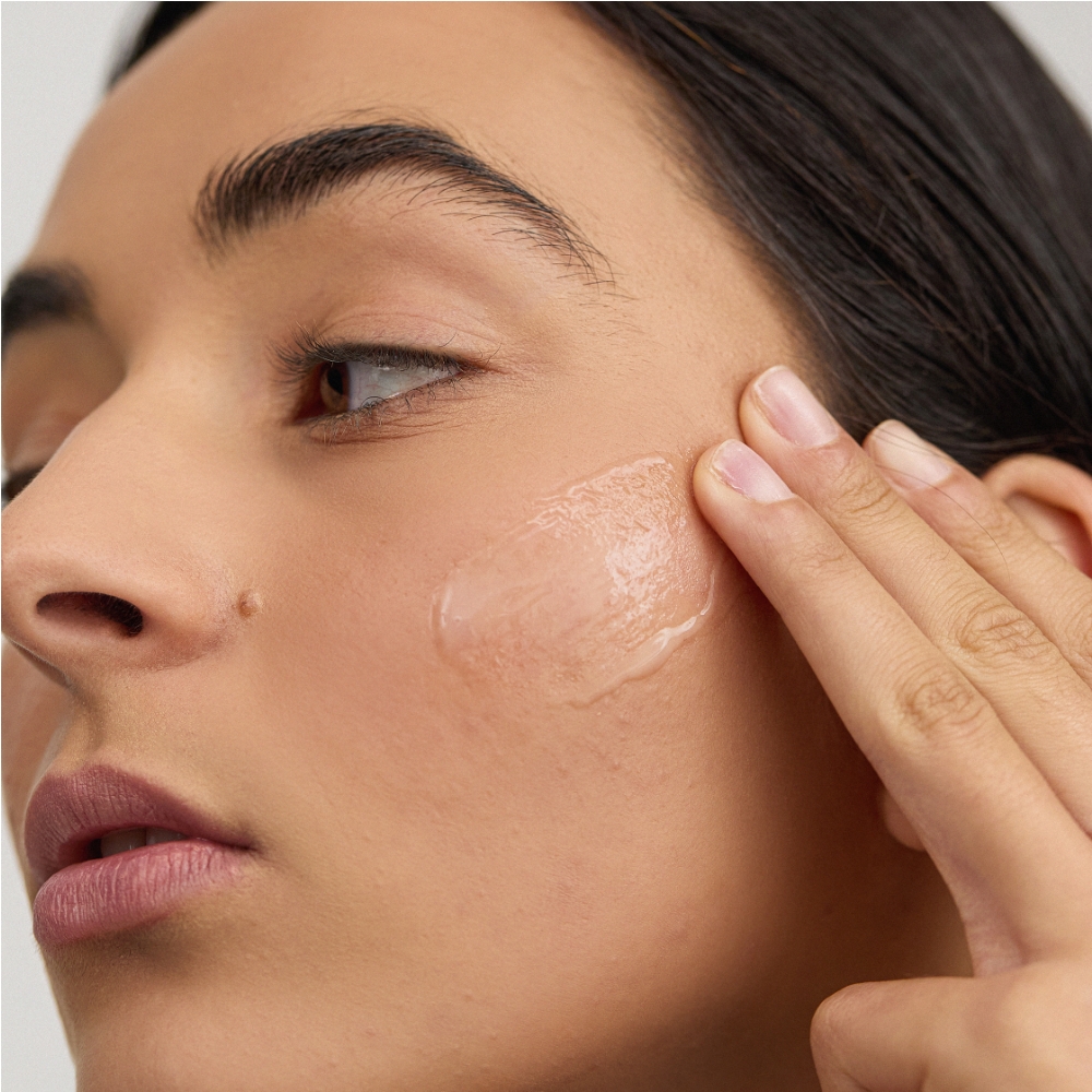 Lady applying INSKIN.CO Vitamin C Serum on checks