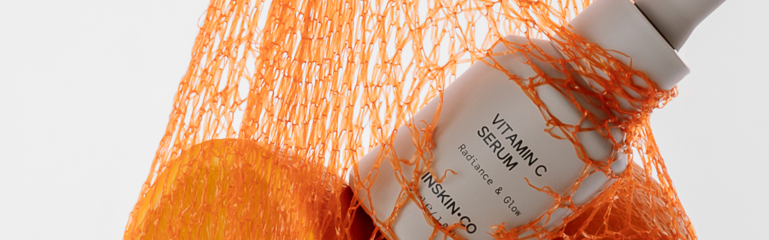 INSKIN.CO Vitamin C Serum in orange bag with oranges
