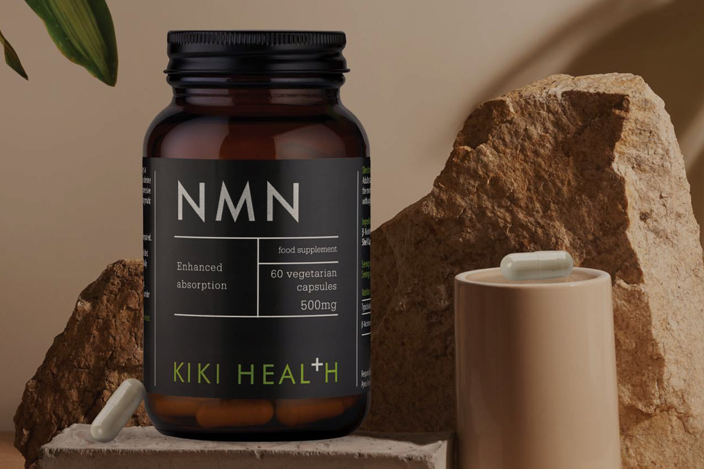 KIKI Health NMN product sitting in front of a beige background with capsules