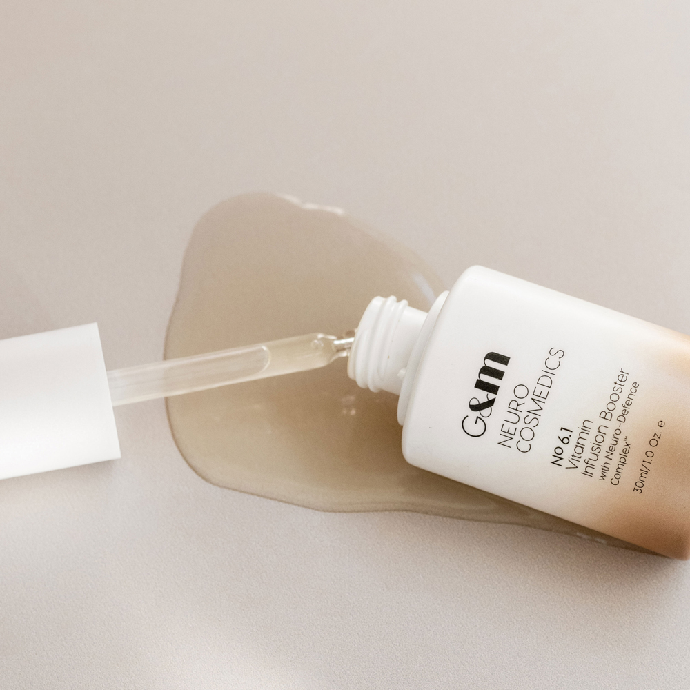 NEUROCOSMEDICS by GINGER&ME Vitamin Infusion Boost lying on side with serum dripping around it