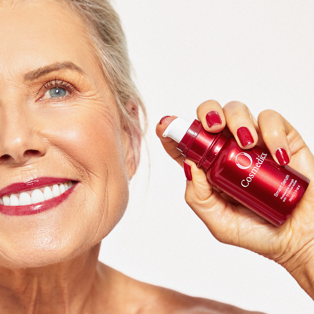 Lady holding O COSMEDICS Smart Serum in hand