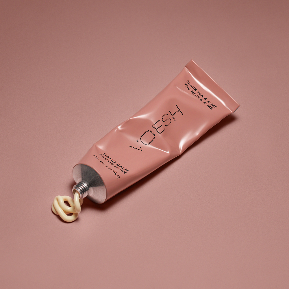 VOESH Hand Balm Black Tea & Rosé being squeezed out of tube