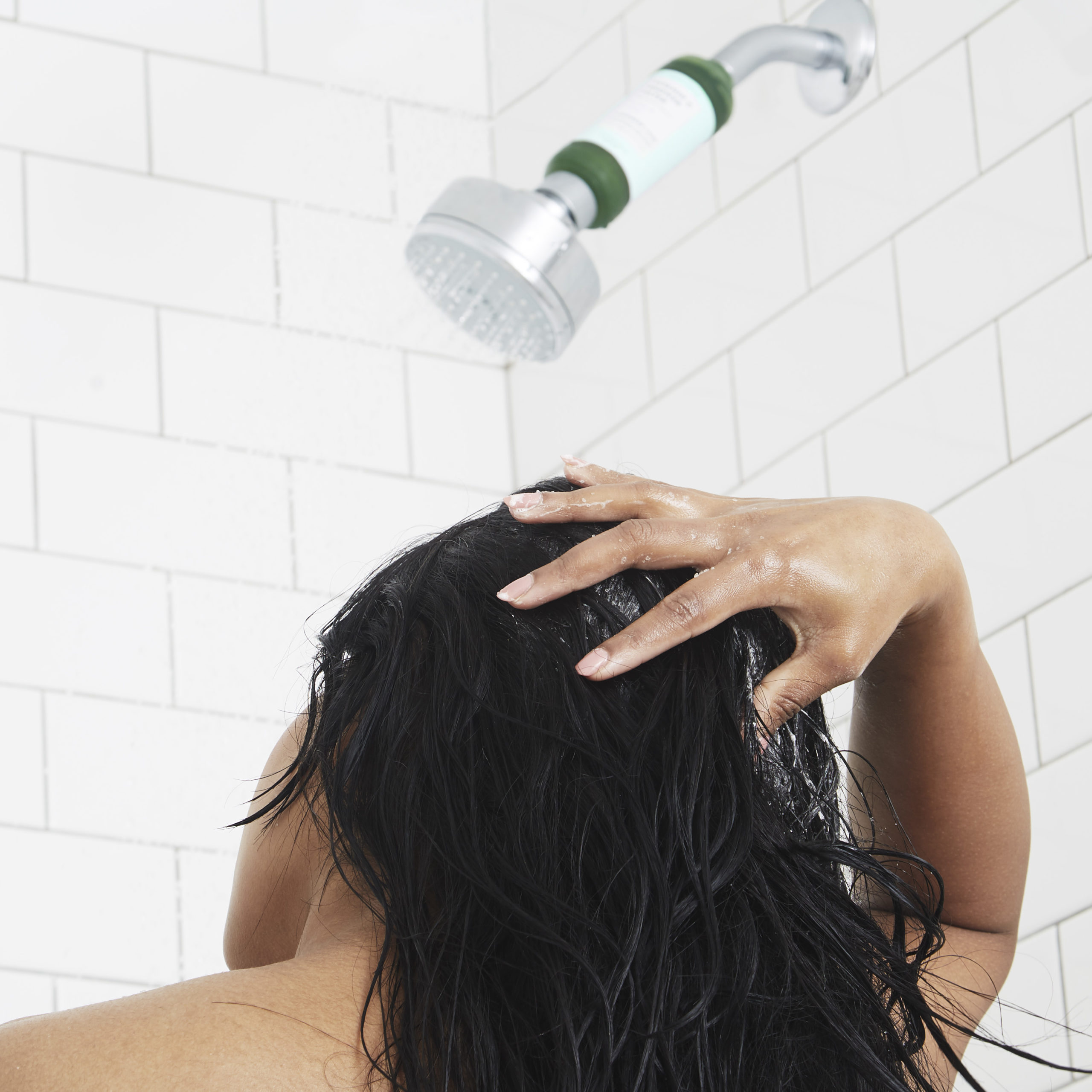 VOESH Sugar Scrub Bubble Wash being applied to hair in shower with shower filter in background