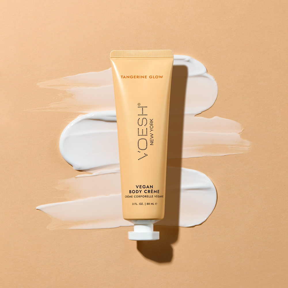VOESH Vegan Body Creme Tangerine Glow with product texture on orange background