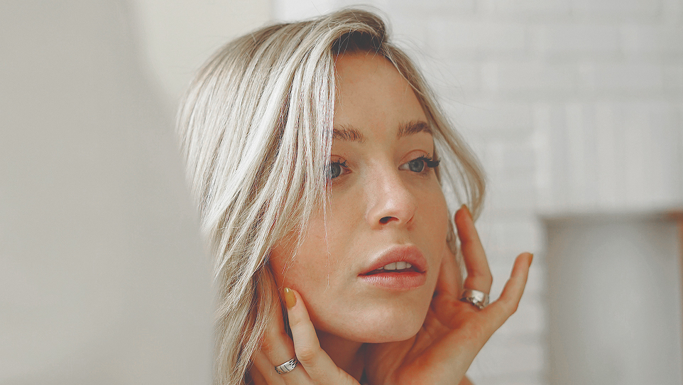 Teen looking at face in mirror close up