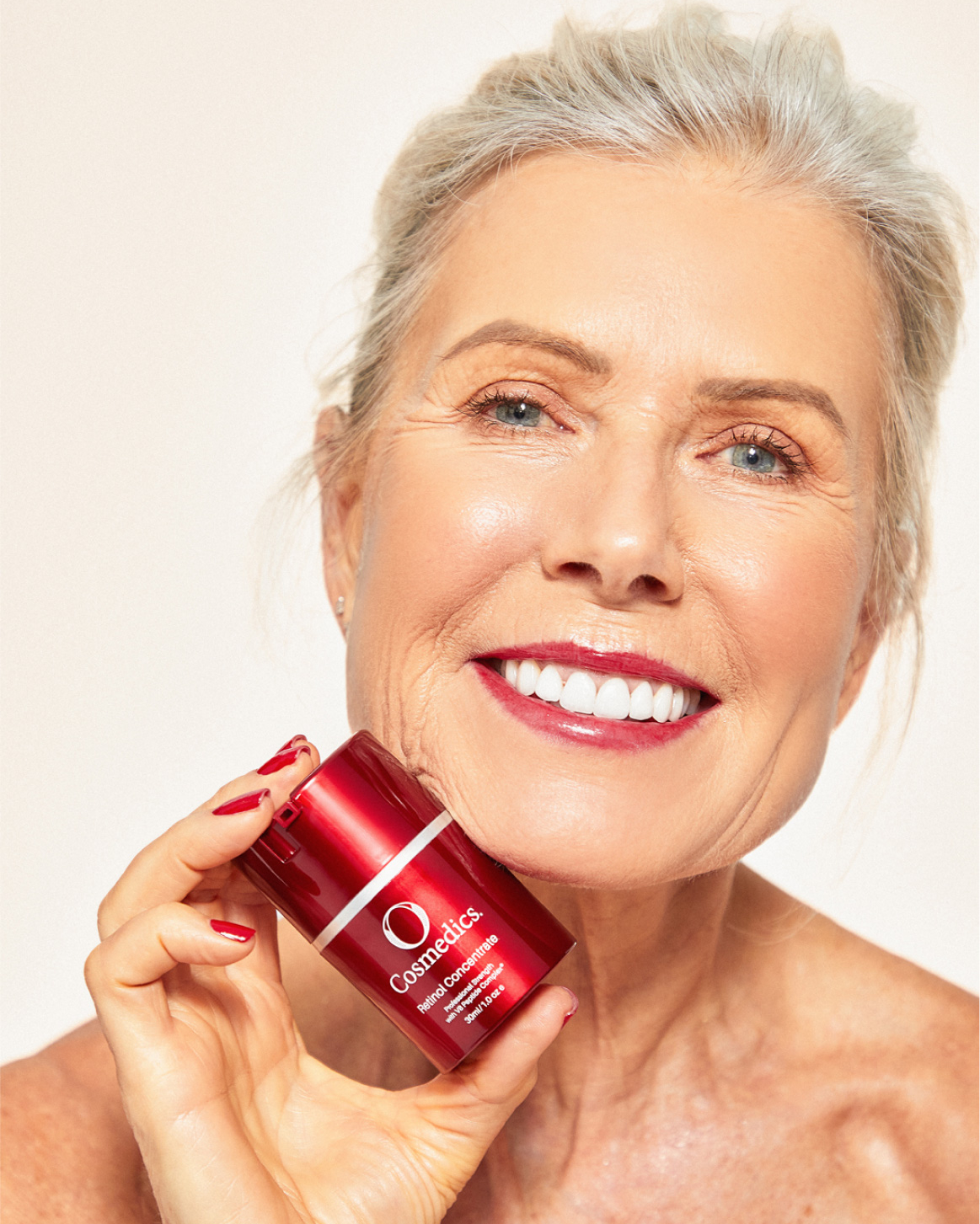mature woman holding o cosmedics retinol concentrate