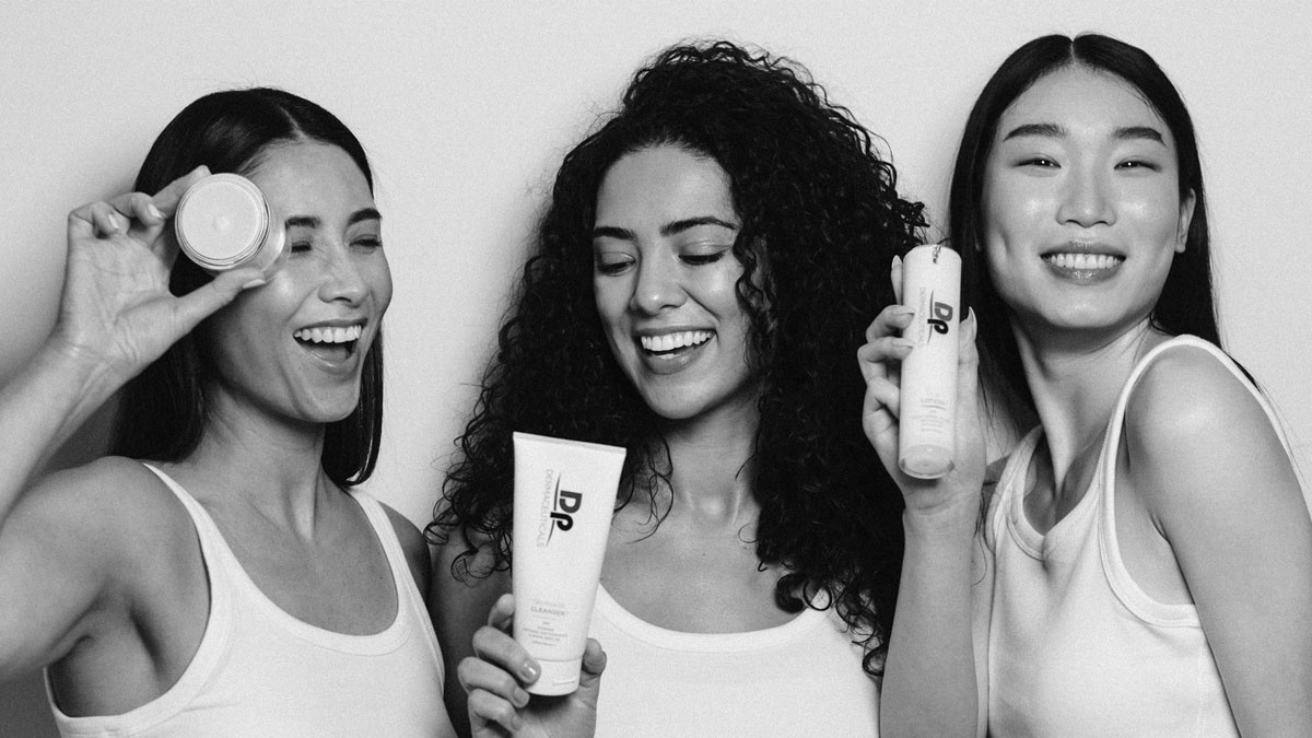 Women holding clinical grade skincare black and white image