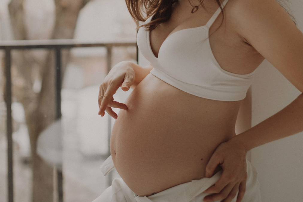 Pregnant lady showing bare skin belly